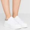 Emporio Armani Trainers - White/Ecru -Stride Shop 0d92ea4459714c03b182167f0601de41
