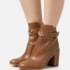 MICHAEL Michael Kors Darcy Heeled - Ankle Boots - Brown -Stride Shop 17c3adb4e9984c84879b0fb160e87348