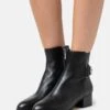 MICHAEL Michael Kors Madelyn Bootie - Classic Ankle Boots - Black -Stride Shop e9f6cc1ccb3a4d97a32a677421ff8dbc